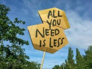 A sign that says all you need is less.