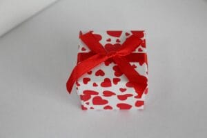 A small red and white heart shaped gift box.