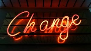 A neon sign with the word change on it.